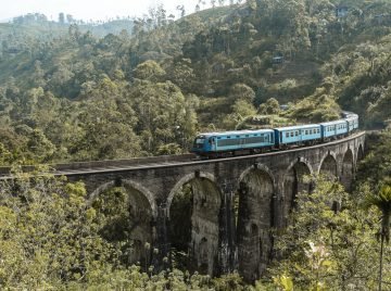 Beautiful shot of a blue train on the Nine Arch Bridge in Sri Lanka