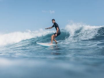 sports man surfing wave on surf board in ocean